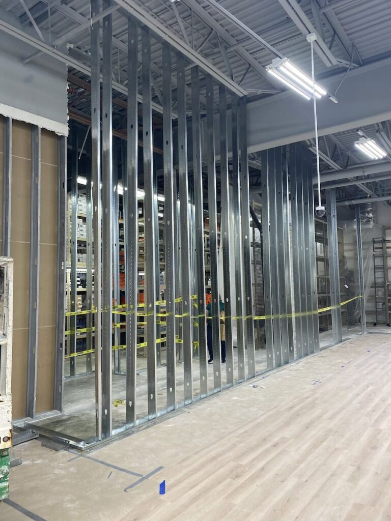 Steel stud partition framing and layout construction within active retail remodeling project