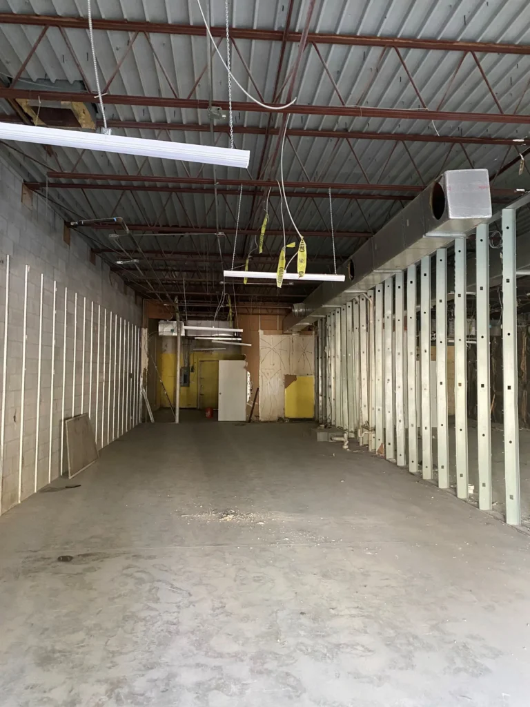 Inside a warehouse, a wide open space is visible