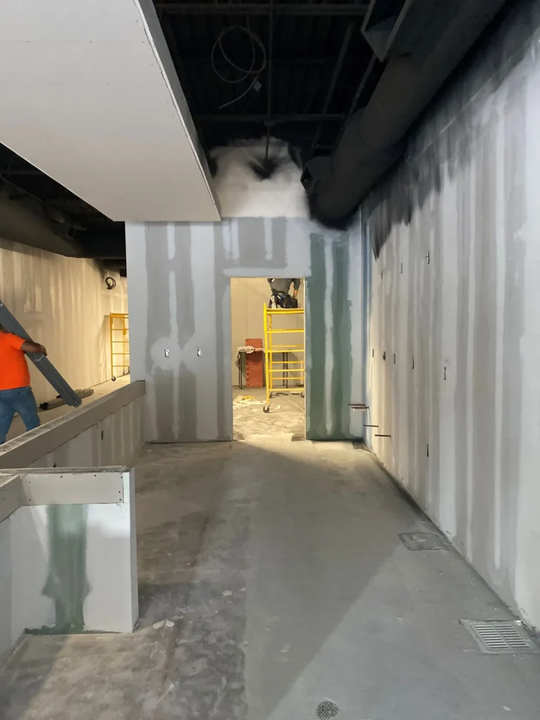A man stands in the center of a room