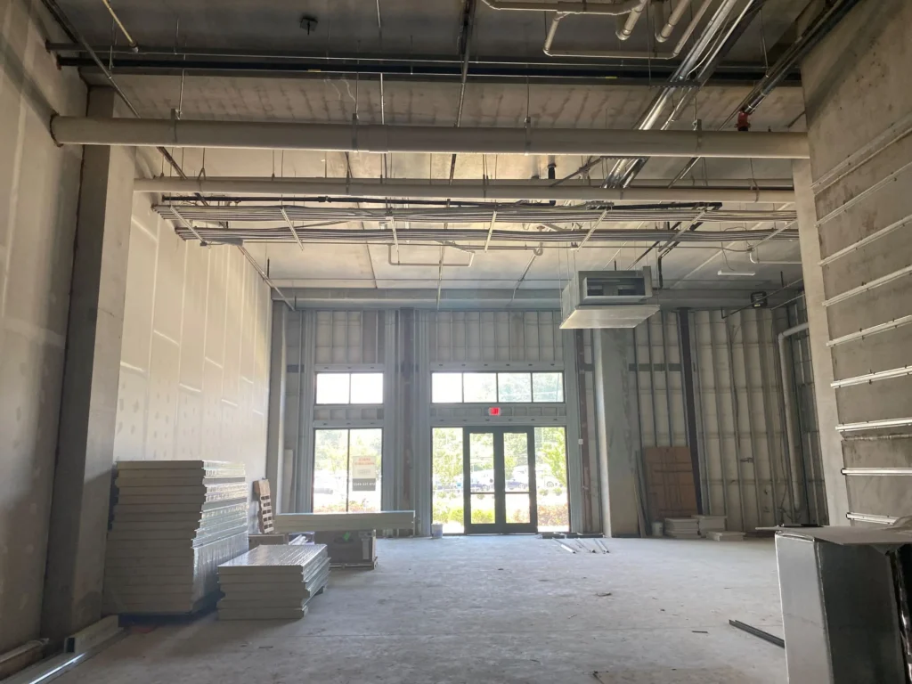 A spacious, empty room filled with various construction equipment