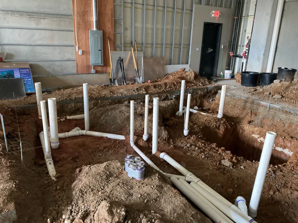 A spacious room featuring visible pipes