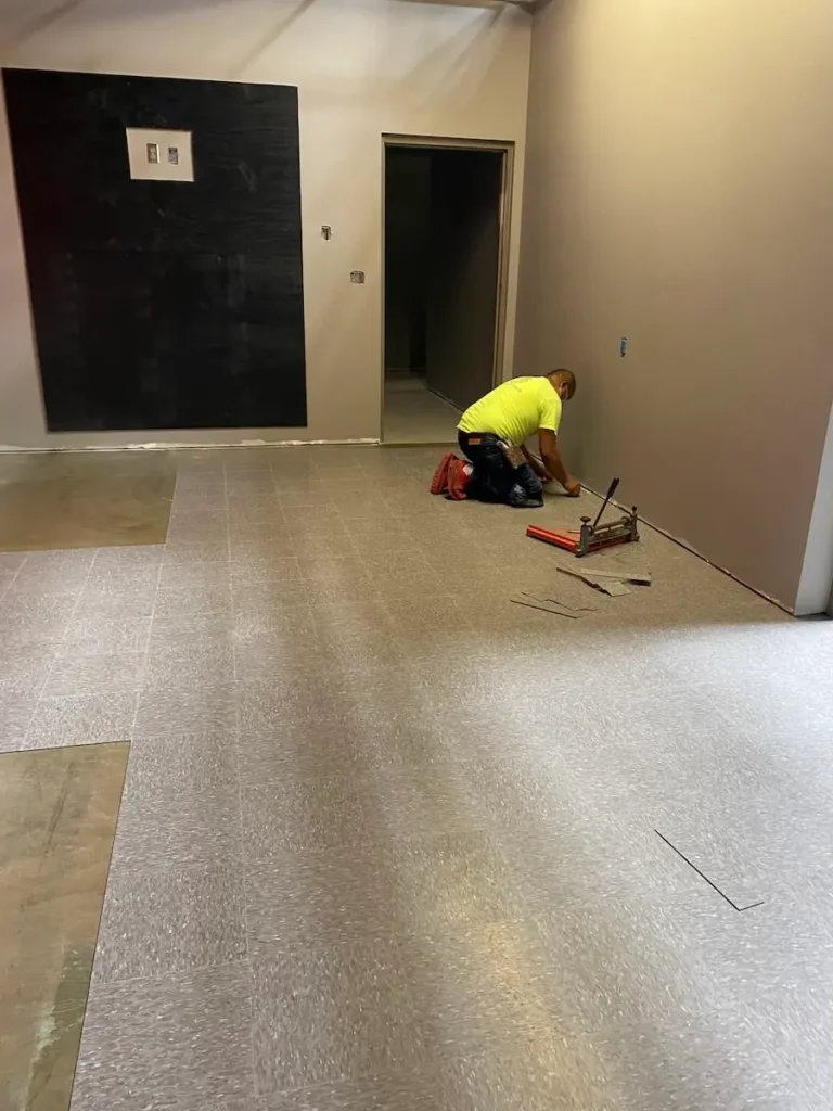 A man is kneeling on the floor