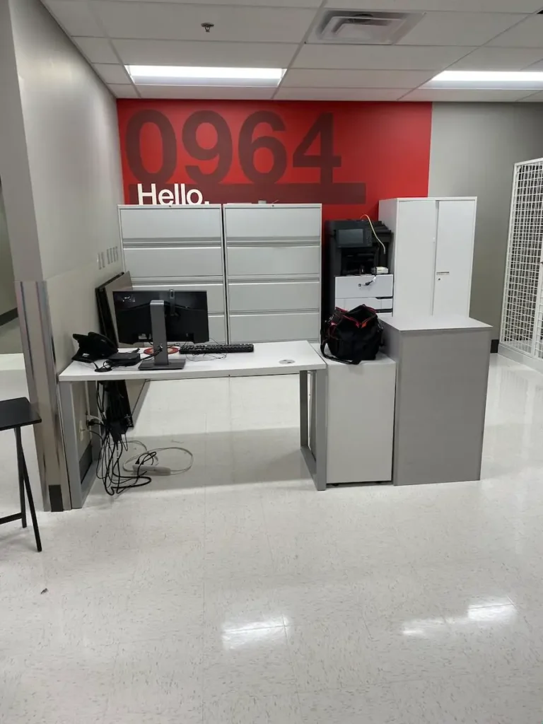 A spacious open office featuring a desk with a computer