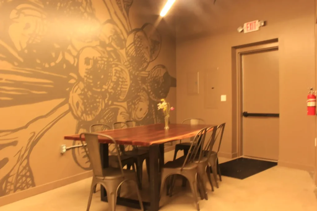 A dining room featuring a colorful mural on the wall
