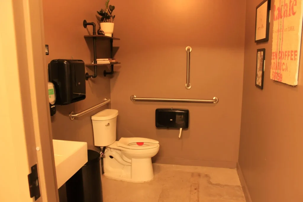A well-lit bathroom with a toilet and a sink