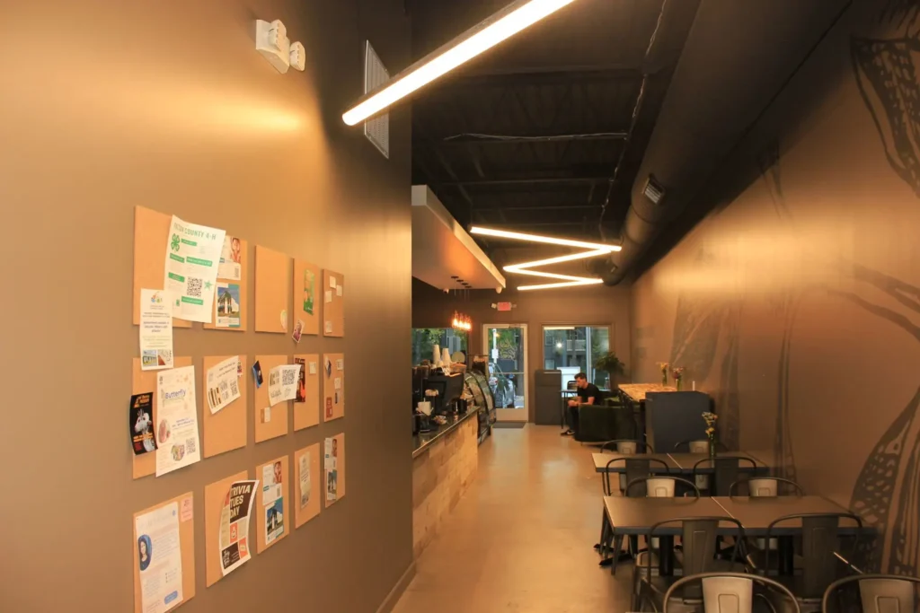 An interior hallway with multiple tables and chairs set up for use
