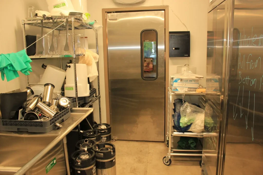 A kitchen featuring a refrigerator and a sink