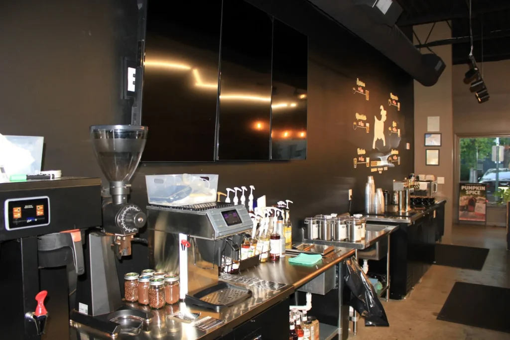 A cozy coffee shop featuring a large television mounted on the wall