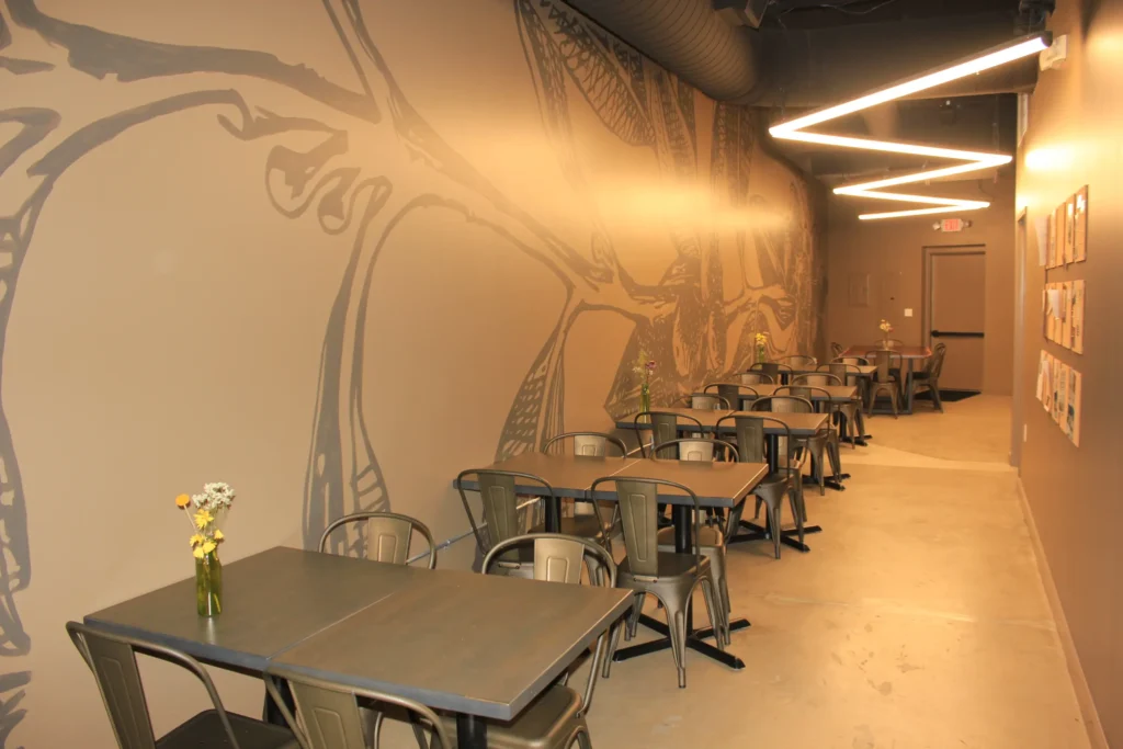 A spacious hallway lined with tables and chairs
