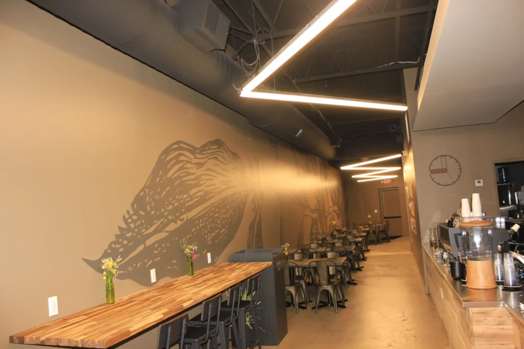 A spacious hallway lined with tables and chairs