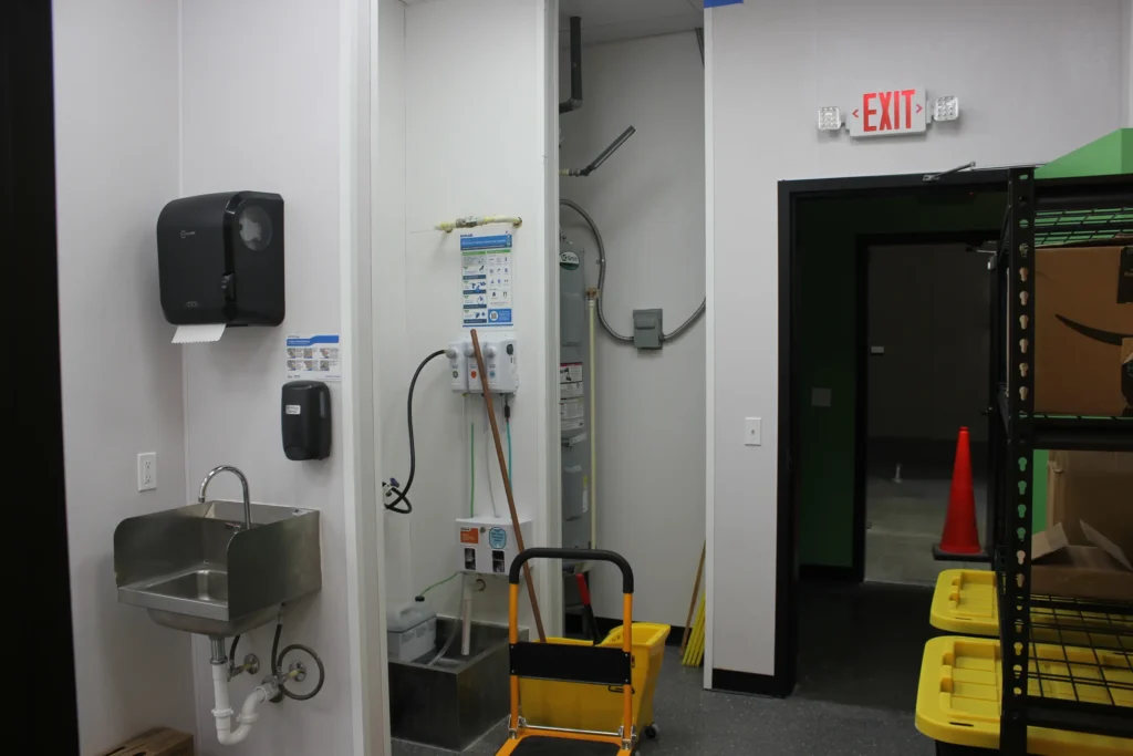 An interior room with a door and a cart