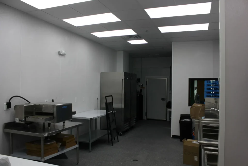 A kitchen featuring a refrigerator and a microwave