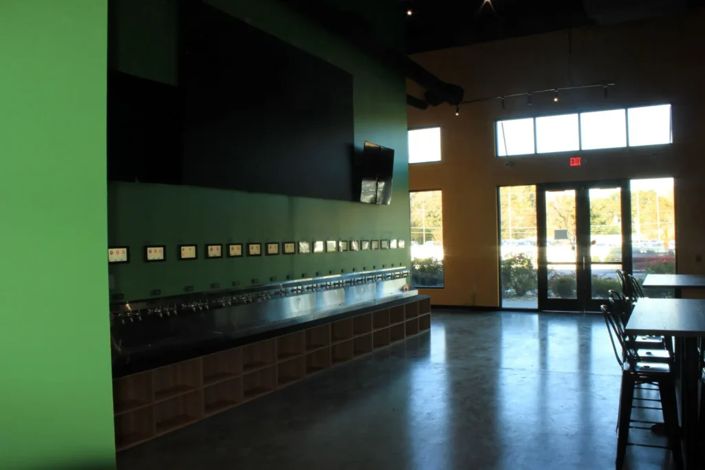 A bar featuring a large screen and a counter
