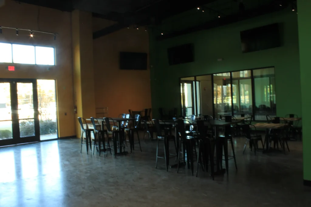 A large room featuring several tables and chairs