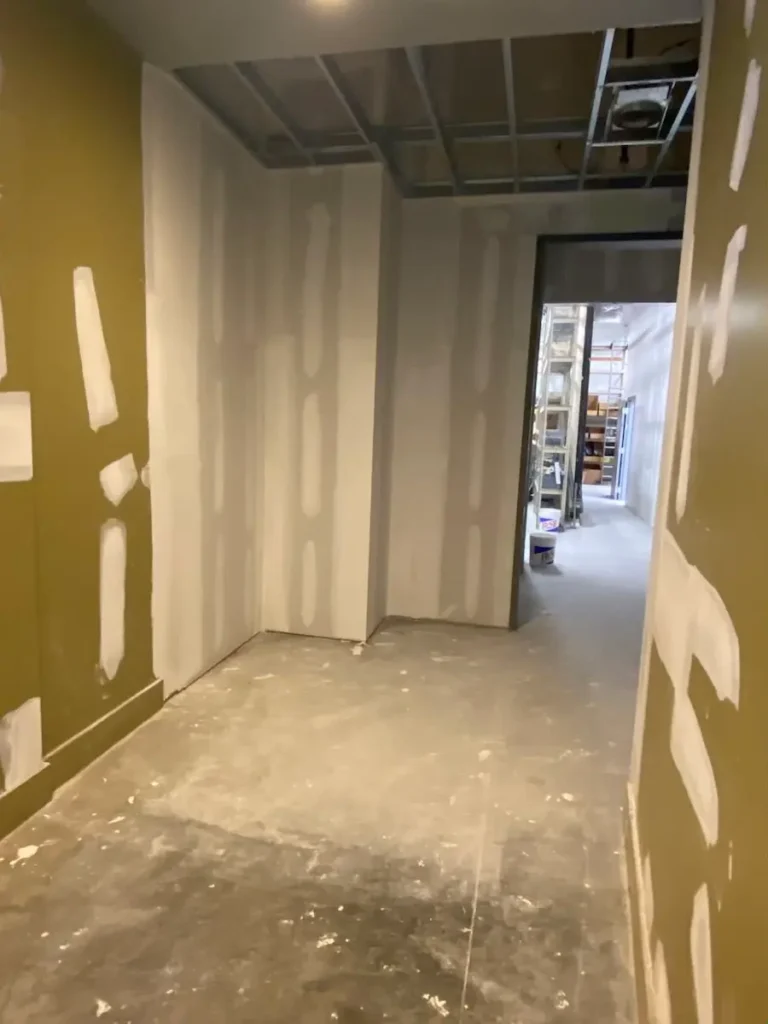 hallway featuring drywall and freshly painted walls