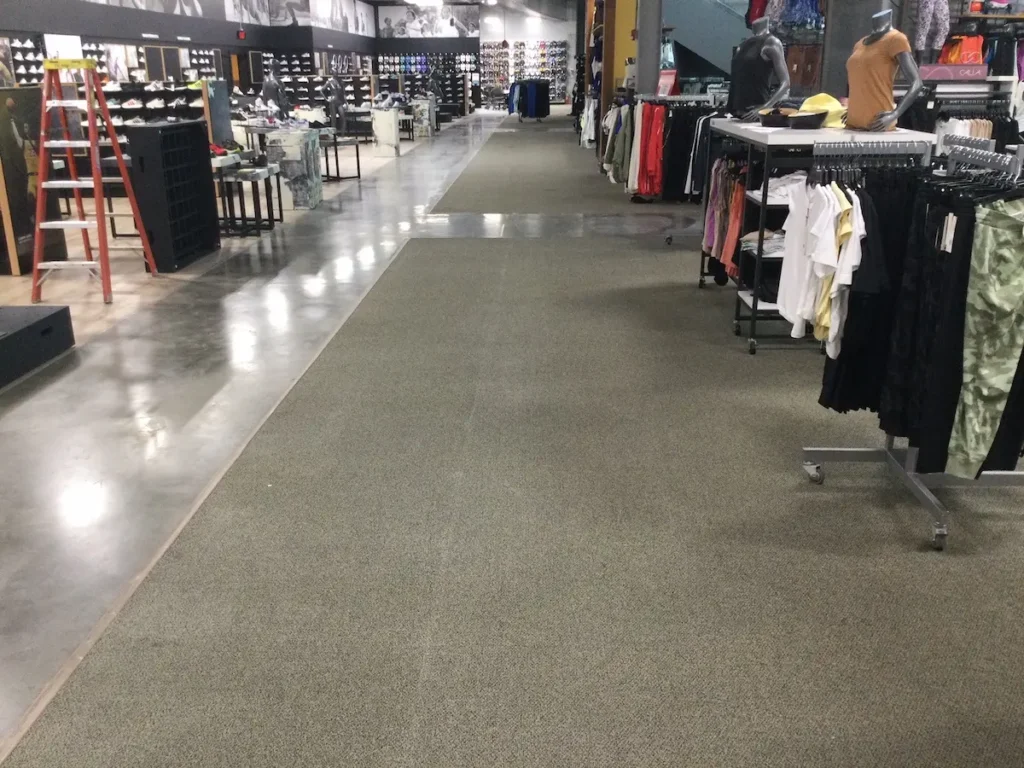 A cluttered store interior with clothes