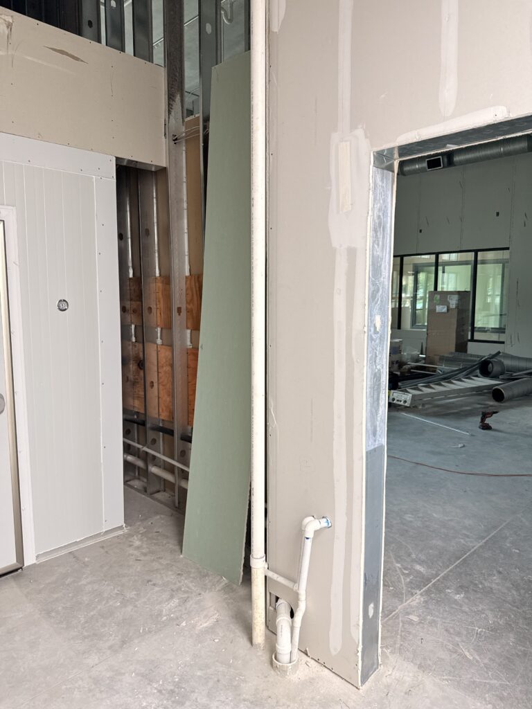 Drywall installation and doorway framing completed in commercial taproom build-out