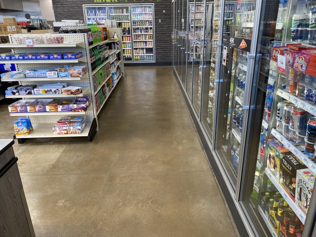 Convenience store aisle with beverage coolers and remodeled retail sales area