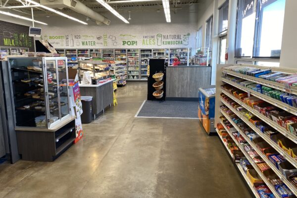 Completed Hy-Vee gas station convenience store remodel featuring polished concrete flooring, retail shelving, food service displays, beverage coolers, and upgraded interior finishes.