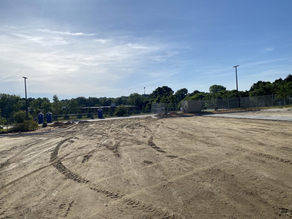 Compacted subgrade ready for aggregate base installation in commercial parking lot project