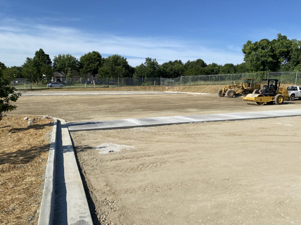 Parking lot subgrade preparation and curb installation before asphalt placement