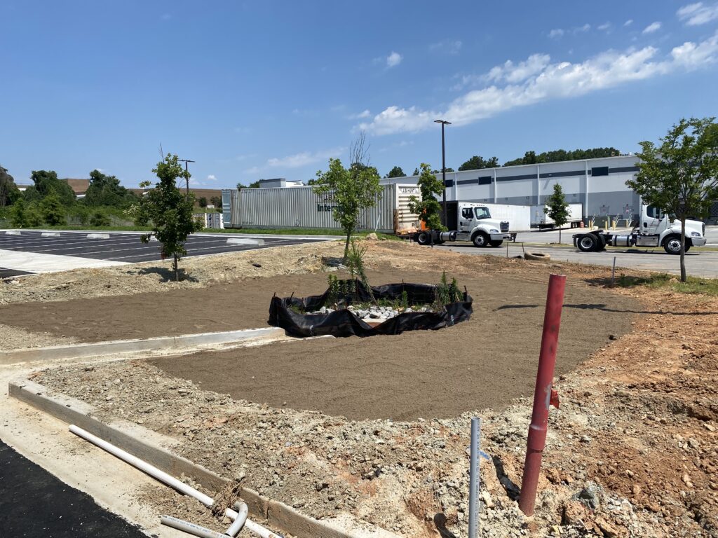 Truck parking lot construction in Decatur GA with roller compacting stone base