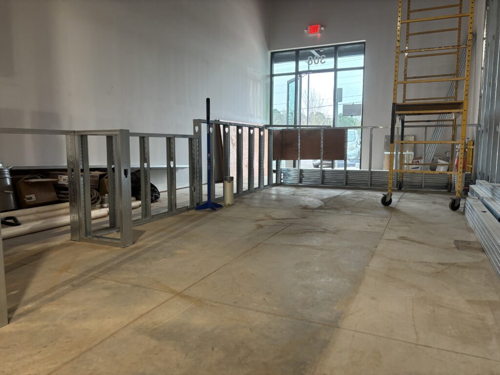 Open restaurant space with completed wall framing ready for drywall installation