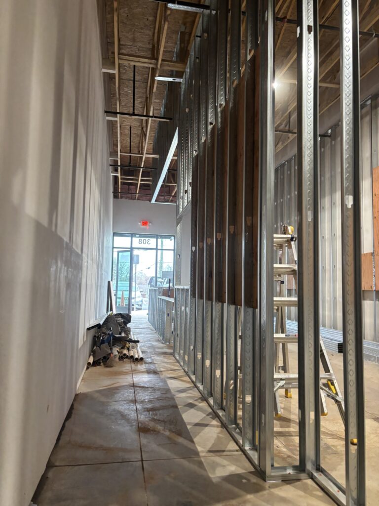 Wall framing and rough-in work during commercial restaurant construction