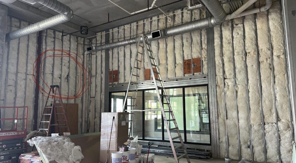 Insulated exterior wall framing and storefront opening preparation in commercial taproom project