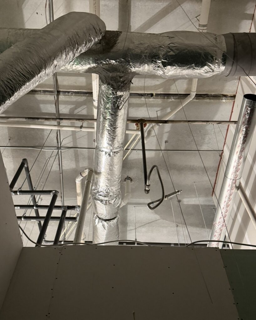 HVAC ductwork installation above commercial restaurant and taproom interior
