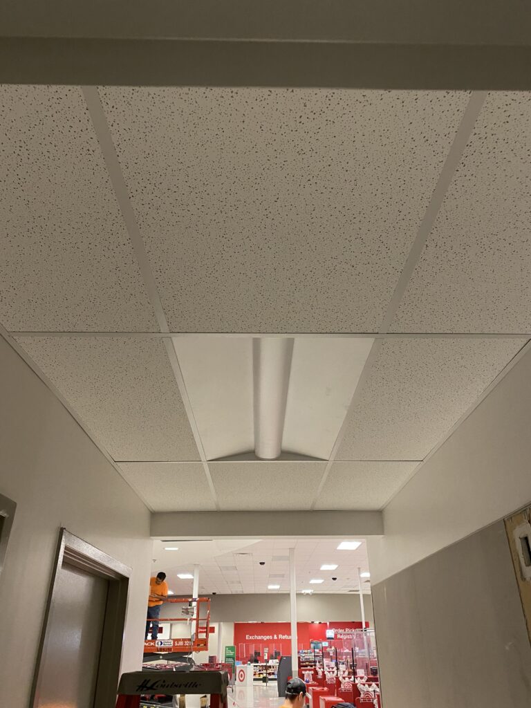 Target commercial remodel corridor with ACT ceiling tiles, lighting installation, and finished hallway construction