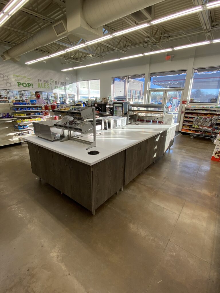 Convenience store remodel featuring freestanding counter island for food prep or service in center of sales floor