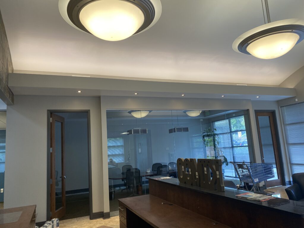 Office reception area with glass conference room and custom interior finishes