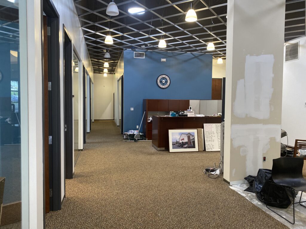 Open office area in Decatur GA with blue accent wall, workstations, and exposed ceiling grid