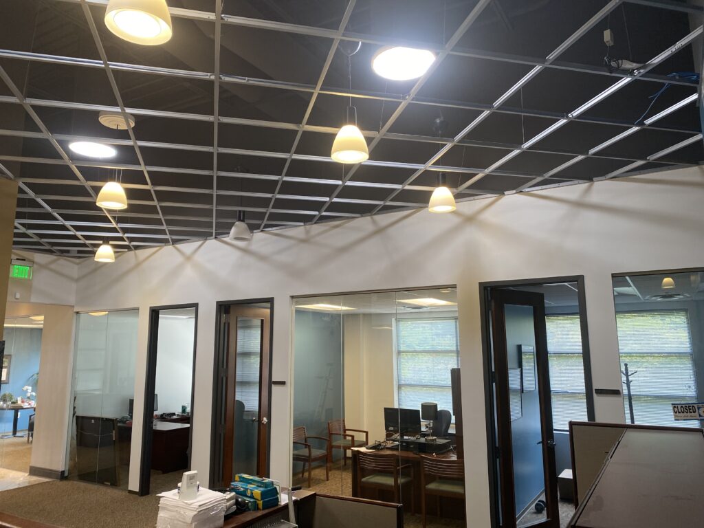 Commercial office interior featuring glass conference rooms and private offices