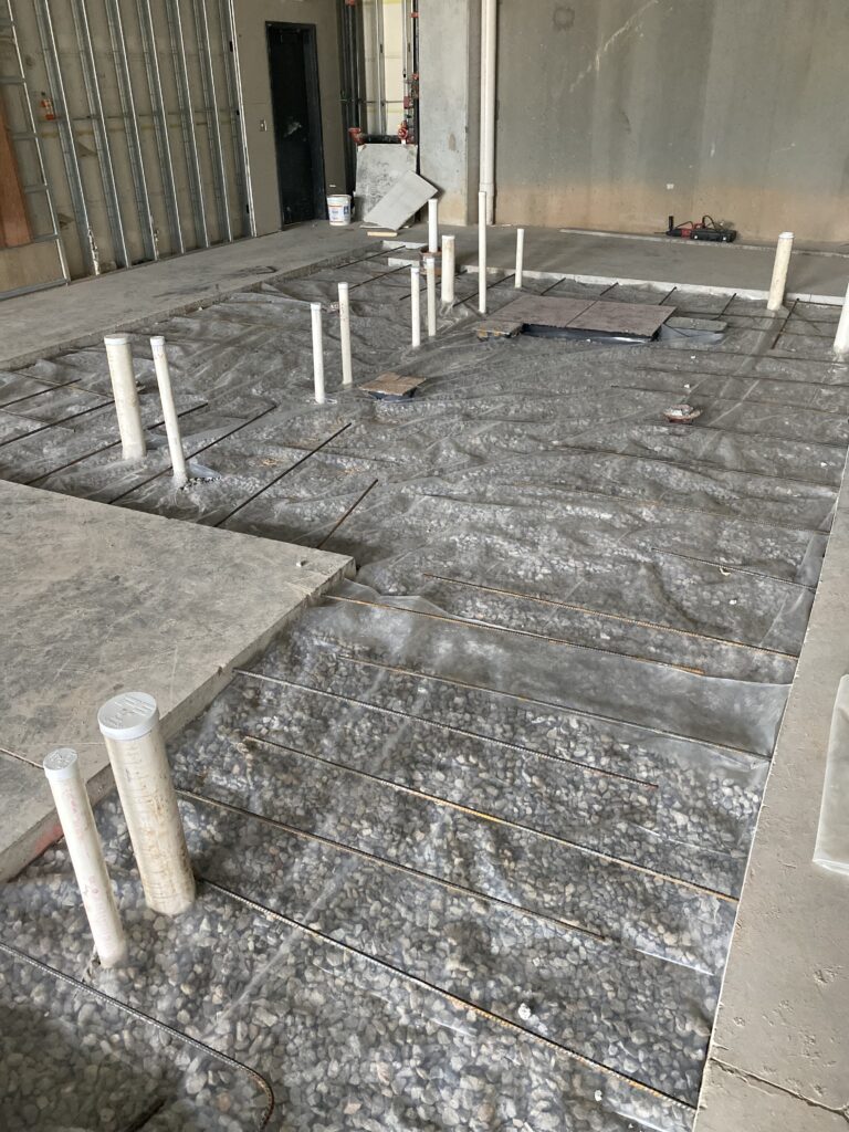 Brews and Hops taproom build out in Chamblee GA with vapor barrier and reinforcement installed over plumbing trenches before concrete pour back