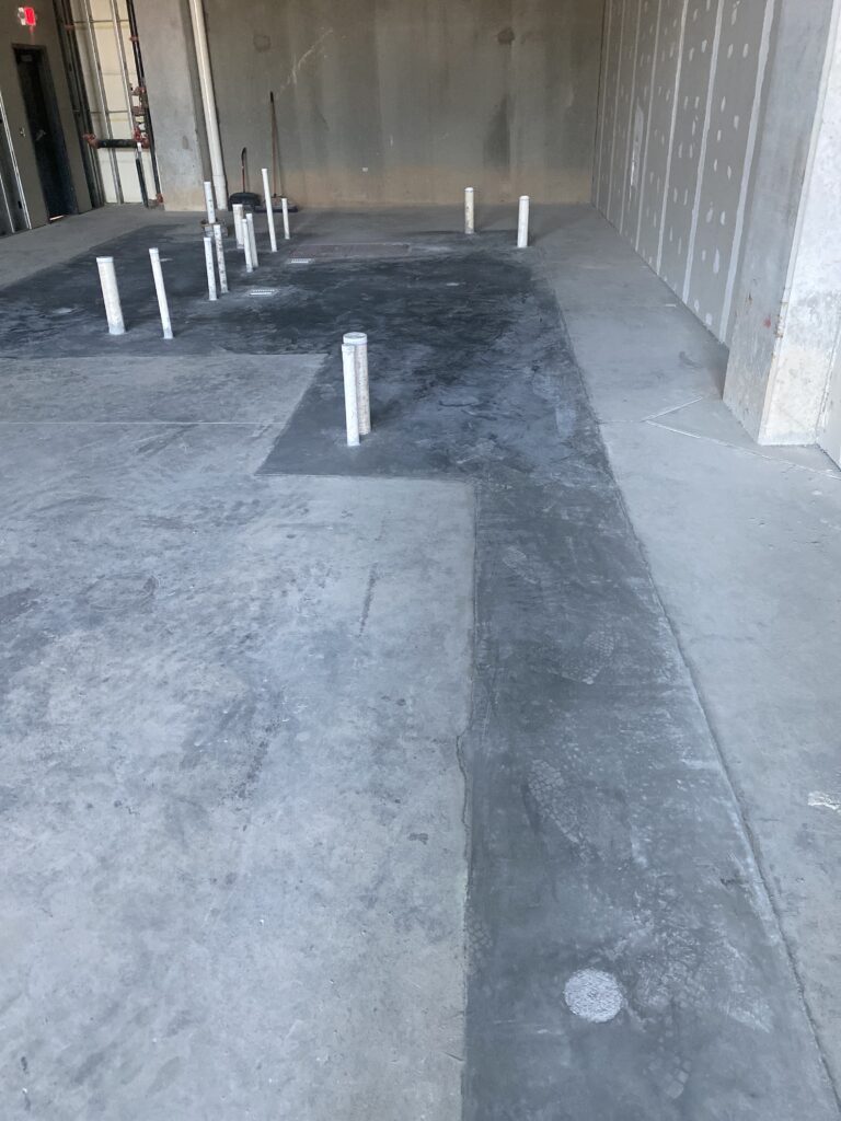 Taproom build out in Chamblee GA showing new concrete pour back over underground plumbing runs in bar area