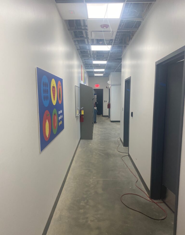 Lidl supermarket employee hallway and back-of-house corridor during final construction and ceiling rough-in work in Decatur GA