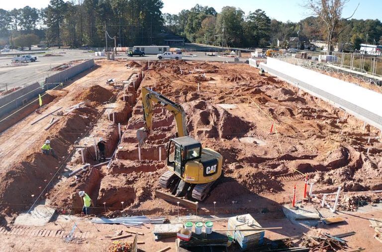 Lidl supermarket mass excavation, underground utility installation, and CMU shell wall construction during ground-up construction in Decatur GA