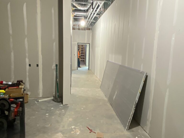 Lidl supermarket interior corridor drywall finishing and commercial build-out progress in Decatur GA