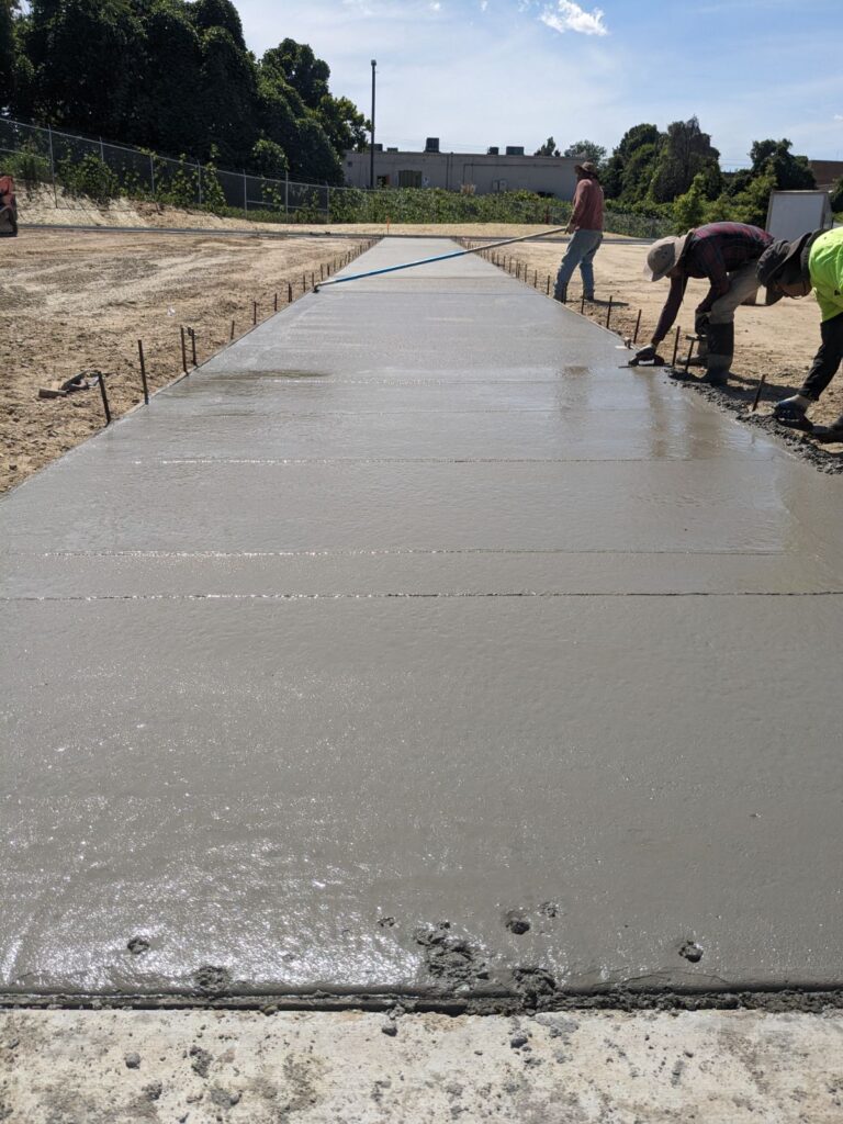 Fresh concrete placement and finishing for commercial pavement construction