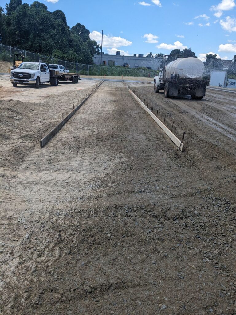 Concrete truck pavement pour in Decatur GA with long forms set for Ross Dress for Less warehouse truck parking lanes