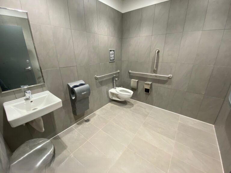 Completed ADA compliant commercial restroom with large format tile finishes at Lidl supermarket in Decatur GA